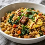 Dr Casey Means weight loss recipe pork cauliflower fried rice in white ceramic bowl on marble