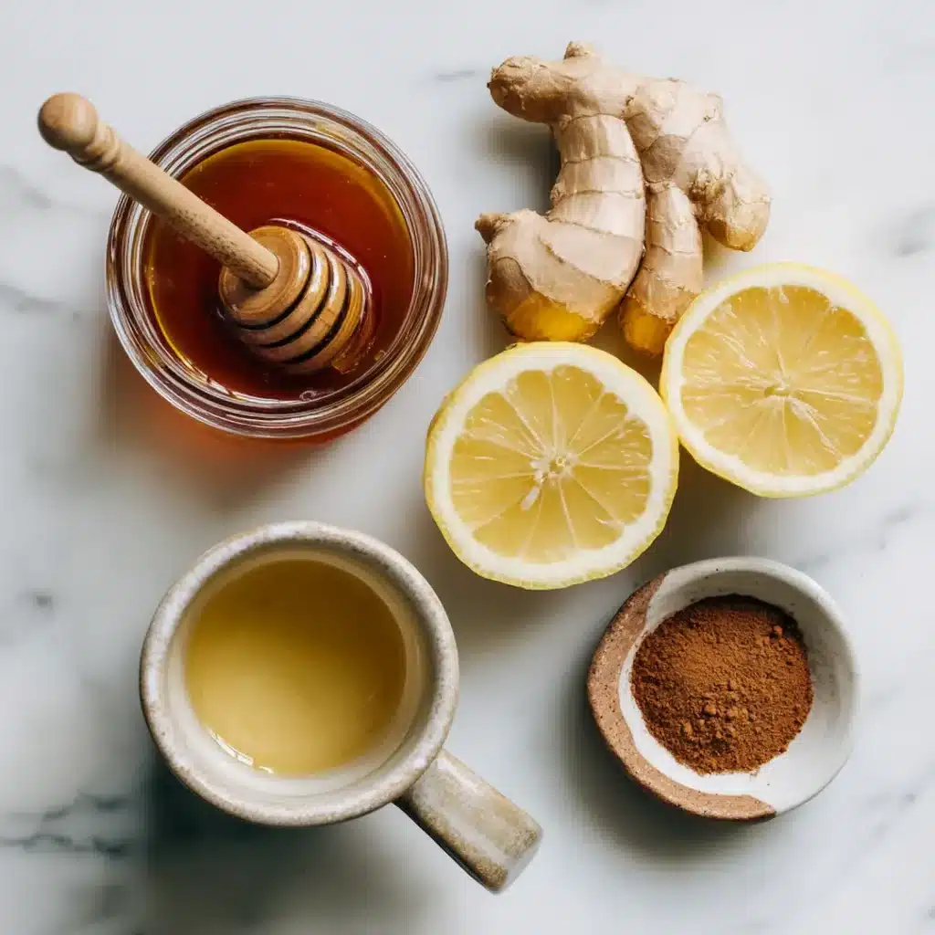 dr-gupta-honey-ingredients dr gupta honey recipe ingredients flat lay with raw
honey jar fresh lemon ginger root and cinnamon on
white marble