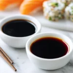 Dark soy sauce and gluten free soy sauce in white bowls on marble