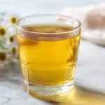 Lipojaro jello recipe in a clear glass with chamomile tea and honey on white marble