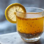 Natural saxenda recipe GLP-1 morning tonic in clear glass with turmeric lemon on white marble surface