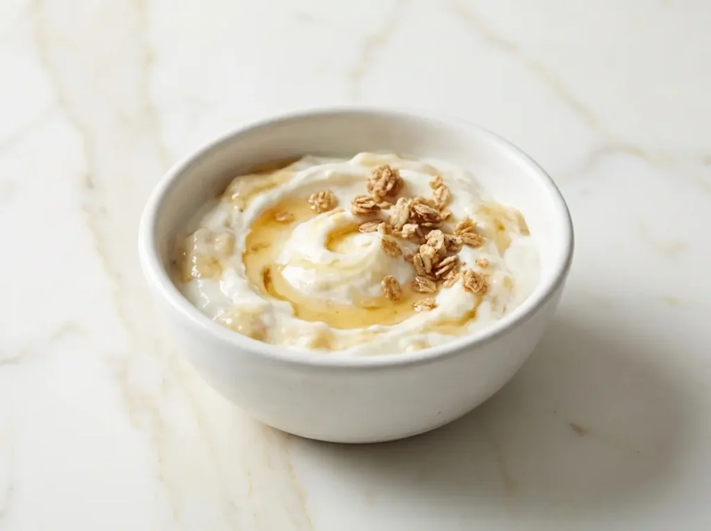 Easy to Digest Recipes for Wegovy Nausea: 7 Gentle Meals That Actually Work 8 Plain low-fat Greek yogurt smoothie bowl with mashed banana, a drizzle of honey, and a sprinkle of plain granola in a small white ceramic bowl on white marble