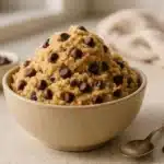 A bowl of edible cookie dough safe without eggs with chocolate chips.